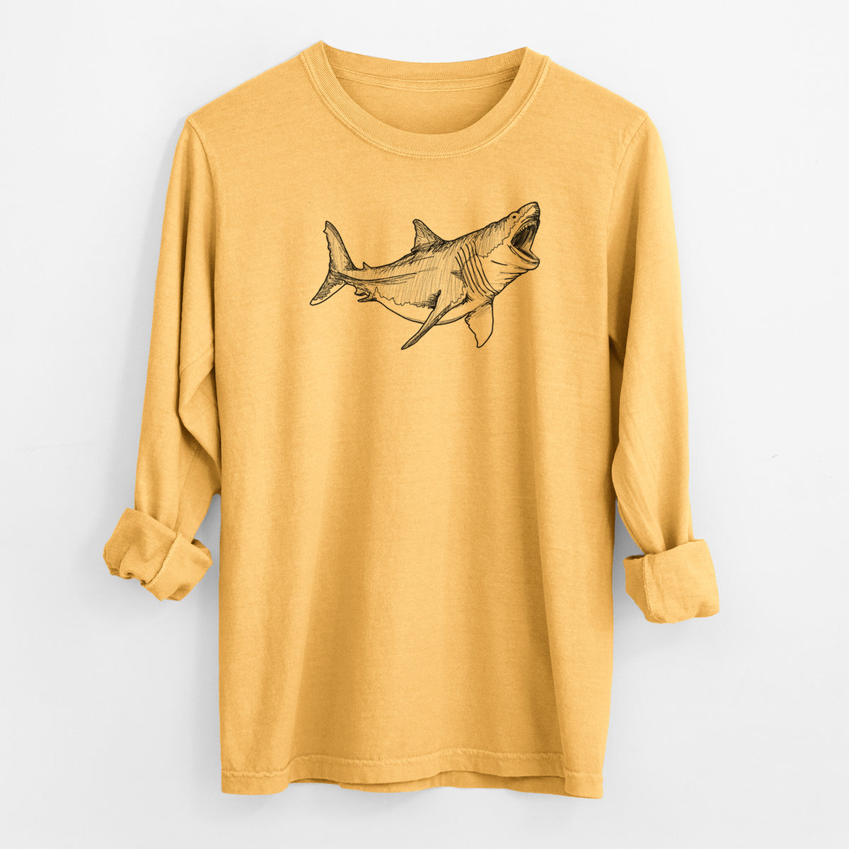 Golden wheat yellow Comfort Colors long sleeve shirt laid flat with the cuffs rolled, printed with a black ink illustration of a megalodon shark with its jaws open.