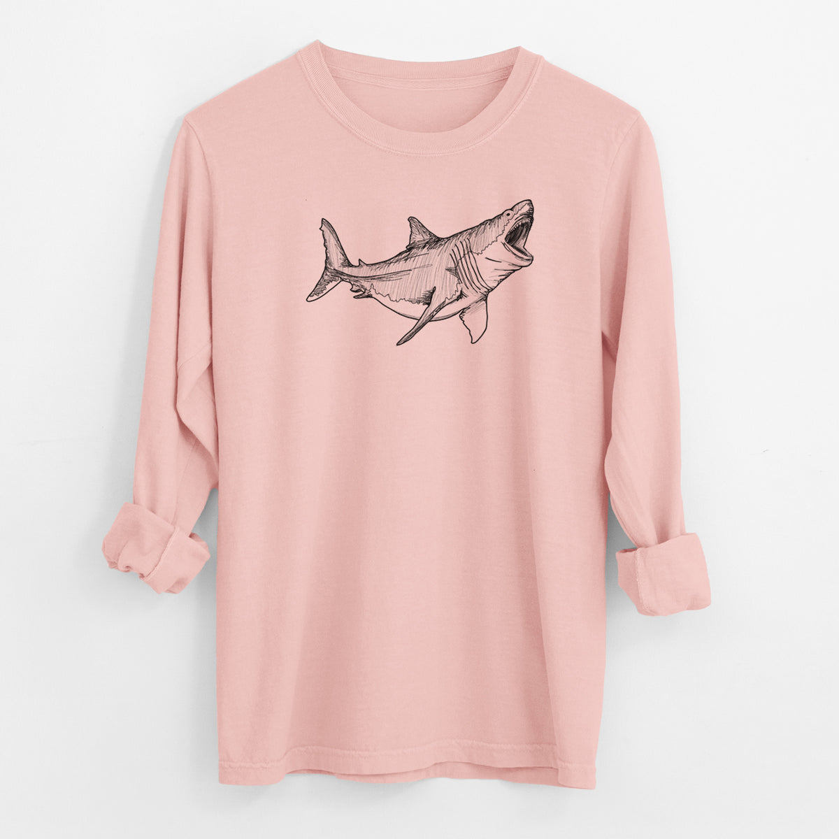 Peachy Comfort Colors long sleeve shirt laid flat with the cuffs rolled, printed with a black ink illustration of a megalodon shark with its jaws open.