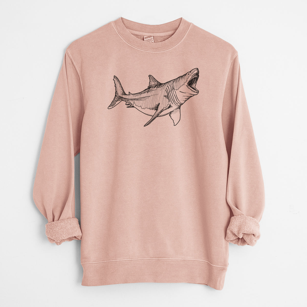 Dusty pink pigment dyed crewneck sweatshirt laid flat with the sleeves rolled, printed with a black ink illustration of a megalodon shark with its jaws open.