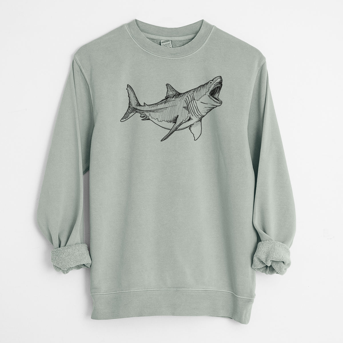 Sage green pigment dyed crewneck sweatshirt laid flat with the sleeves rolled, printed with a black ink illustration of a megalodon shark with its jaws open.