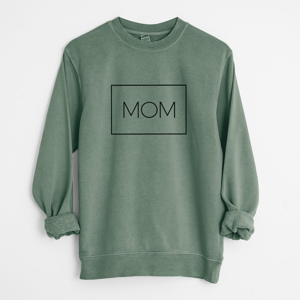 Alpine green pigment dyed crewneck sweatshirt laid flat with the sleeves rolled, printed with the word MOM in thin black letters inside a rectangle outline.
