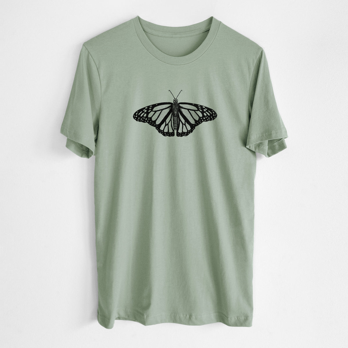 Sage green lightweight cotton t-shirt laid flat, printed with a detailed black ink illustration of a monarch butterfly with its wings spread.