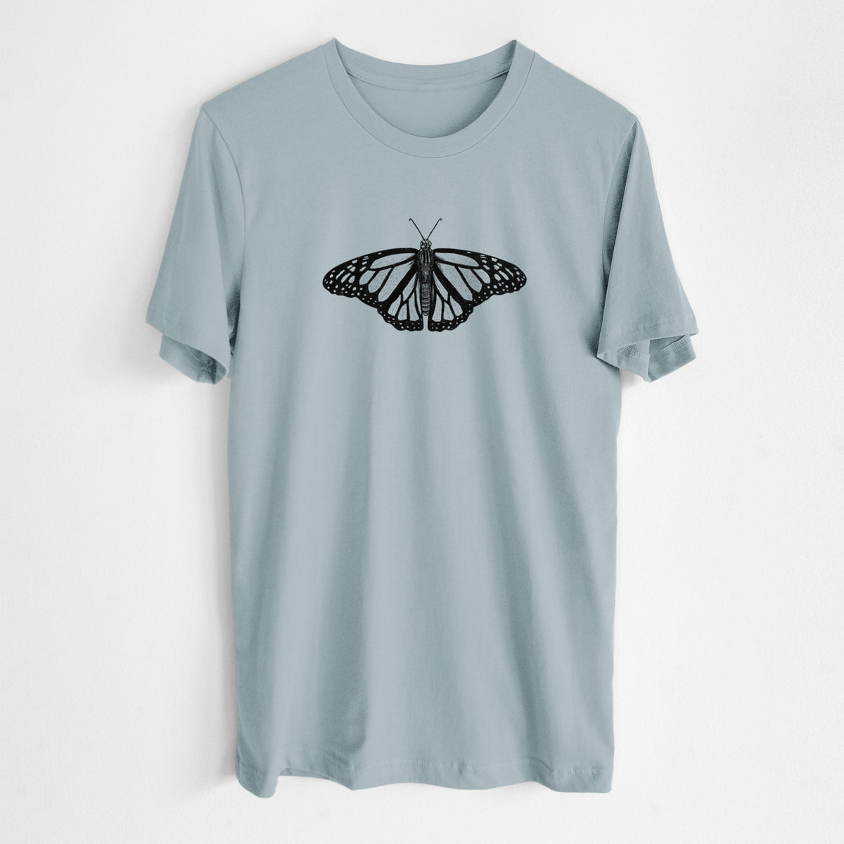 Vintage denim lightweight cotton t-shirt laid flat, printed with a detailed black ink illustration of a monarch butterfly with its wings spread.