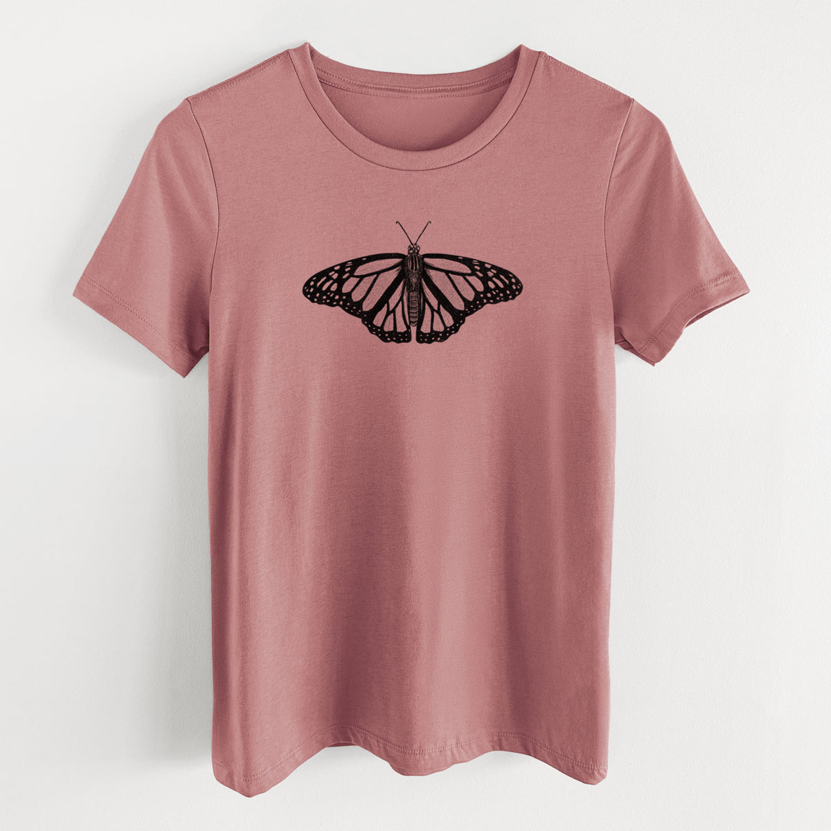 Mauve pink women's relaxed fit cotton t-shirt laid flat, printed with a detailed black ink illustration of a monarch butterfly with its wings spread.