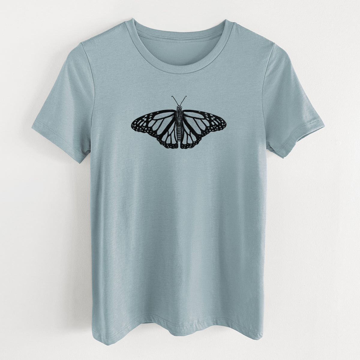 Vintage denim women's relaxed fit cotton t-shirt laid flat, printed with a detailed black ink illustration of a monarch butterfly with its wings spread.