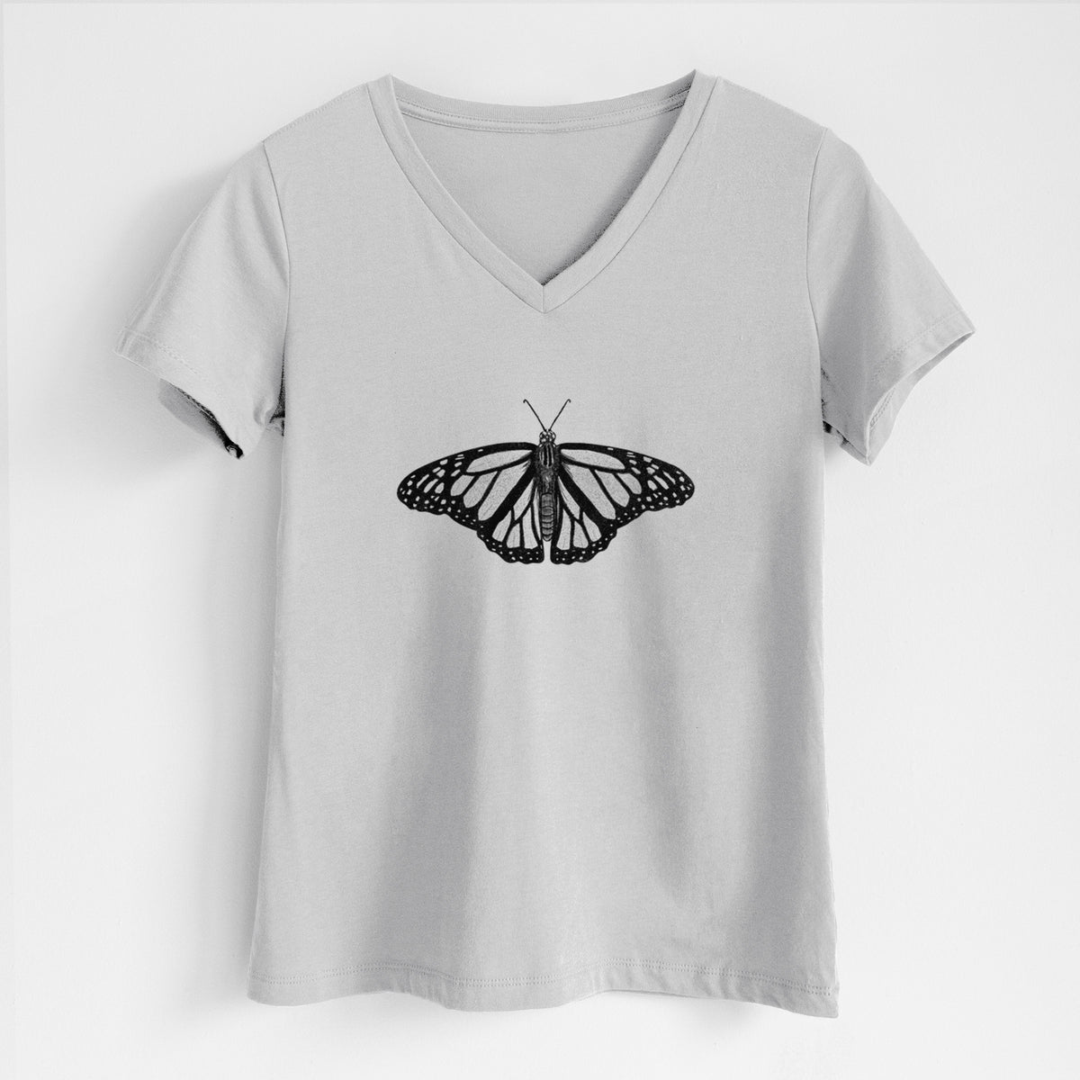 Lunar grey women's relaxed fit cotton V-neck t-shirt laid flat, printed with a detailed black ink illustration of a monarch butterfly with its wings spread.