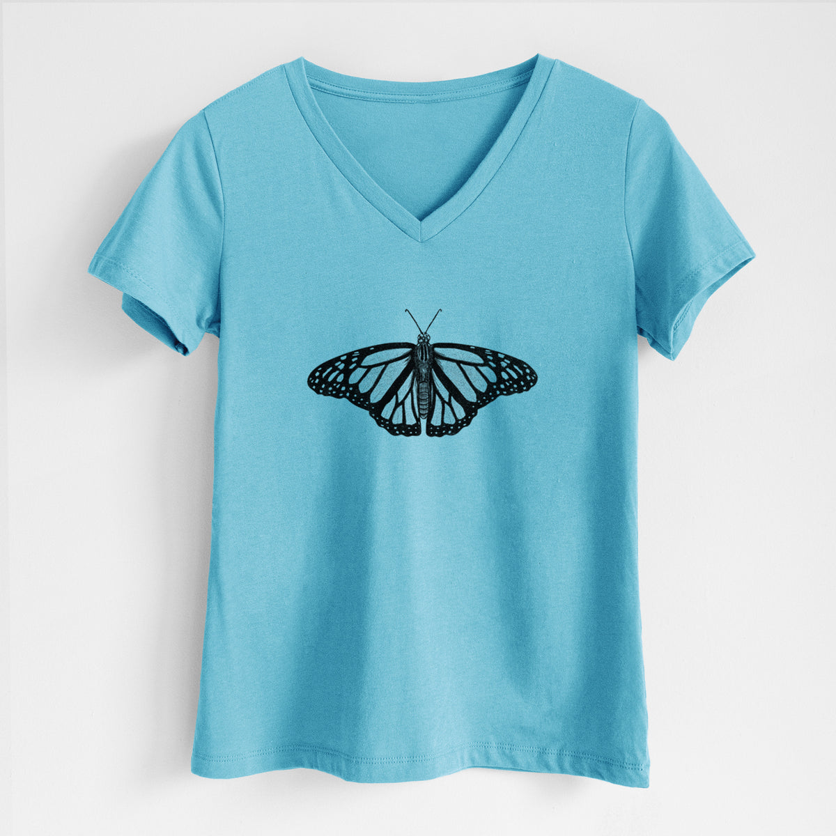 Turquoise women's relaxed fit cotton V-neck t-shirt laid flat, printed with a detailed black ink illustration of a monarch butterfly with its wings spread.