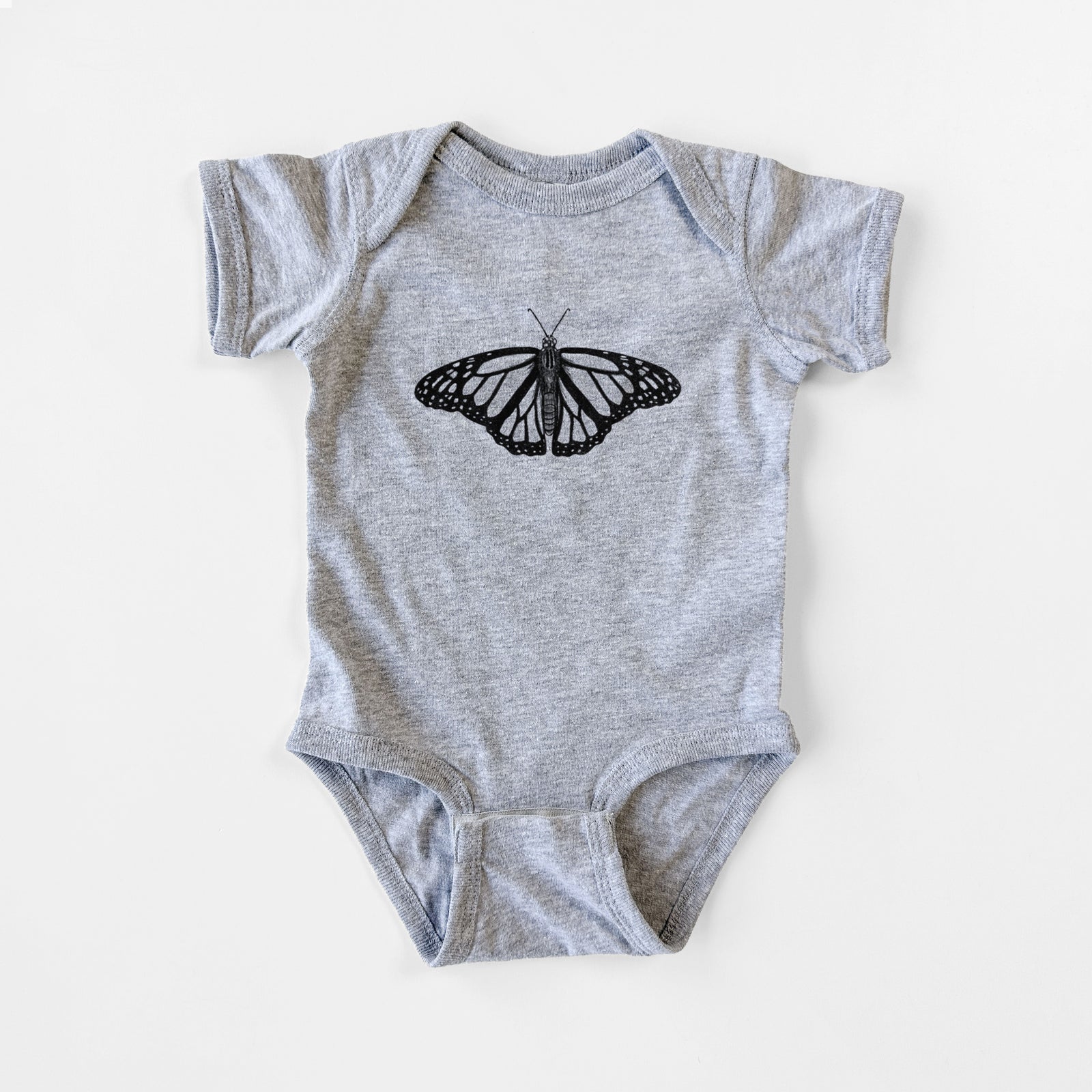 Grey baby bodysuit laid flat, printed with a detailed black ink illustration of a monarch butterfly with its wings spread.