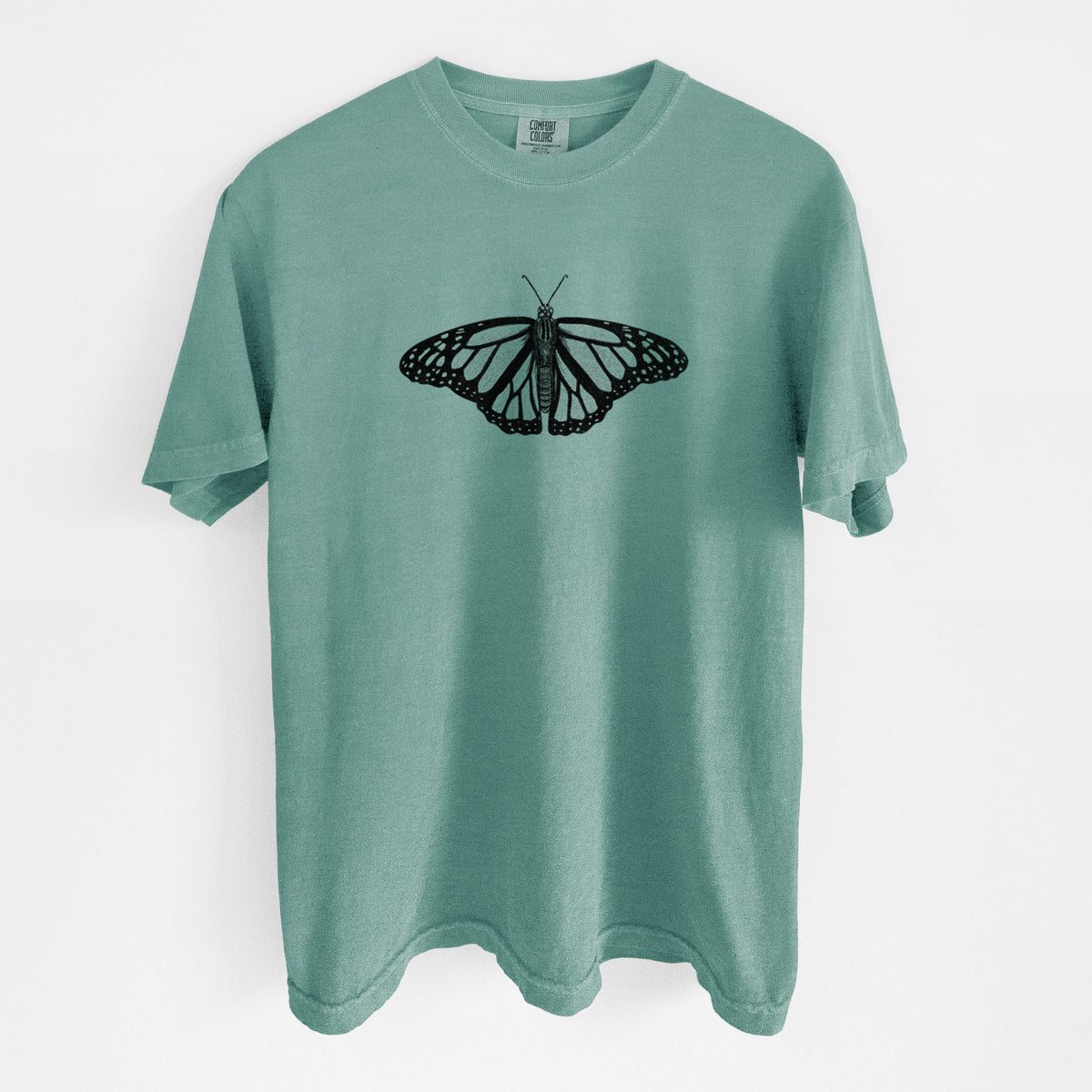 Reef green Comfort Colors t-shirt laid flat, printed with a detailed black ink illustration of a monarch butterfly with its wings spread.
