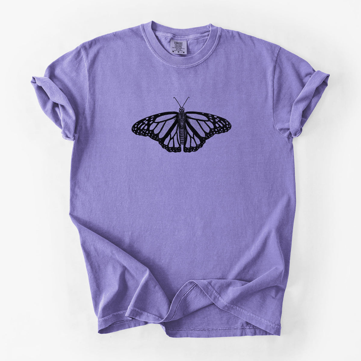Violet purple Comfort Colors t-shirt laid flat, printed with a detailed black ink illustration of a monarch butterfly with its wings spread.