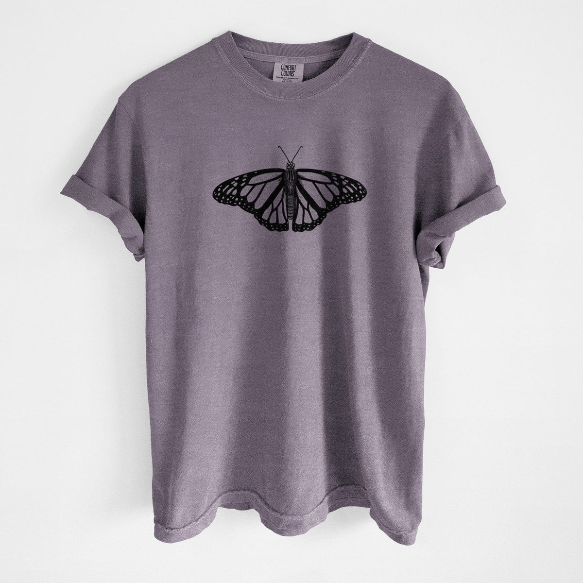 Wine red Comfort Colors t-shirt laid flat, printed with a detailed black ink illustration of a monarch butterfly with its wings spread.