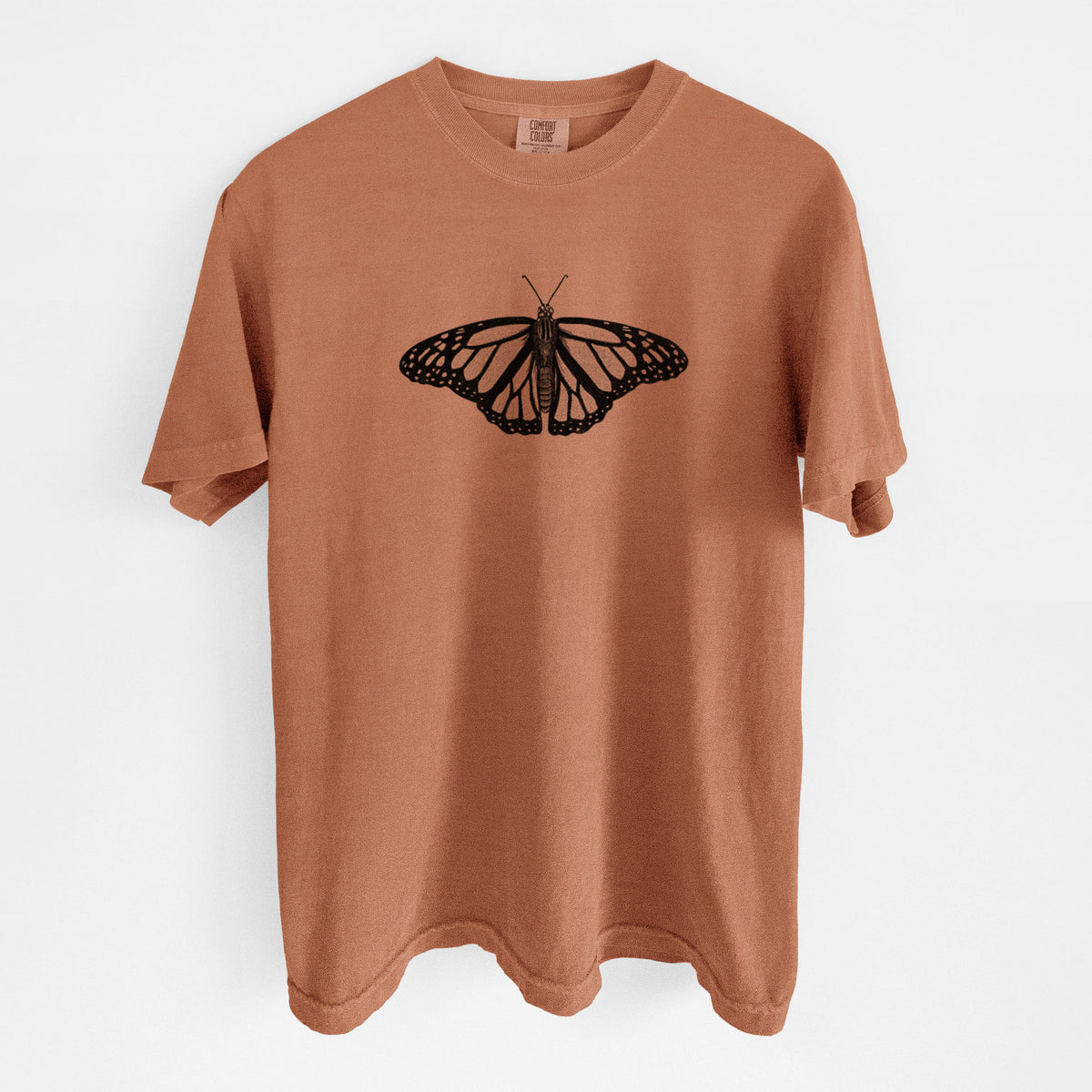 Yam burnt orange Comfort Colors t-shirt laid flat, printed with a detailed black ink illustration of a monarch butterfly with its wings spread.