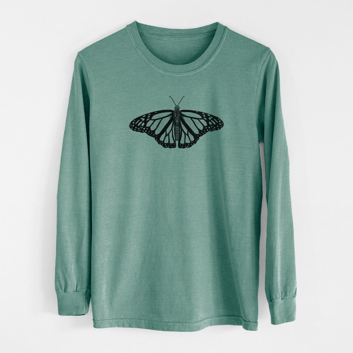 Pine green Comfort Colors long sleeve shirt laid flat, printed with a detailed black ink illustration of a monarch butterfly with its wings spread.