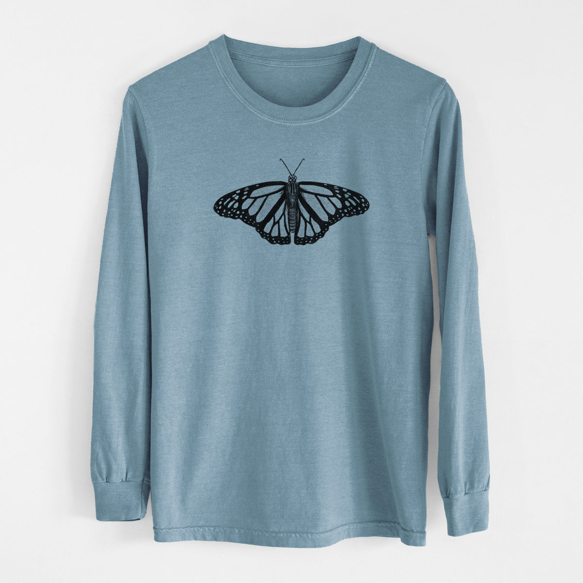 Steel blue Comfort Colors long sleeve shirt laid flat, printed with a detailed black ink illustration of a monarch butterfly with its wings spread.
