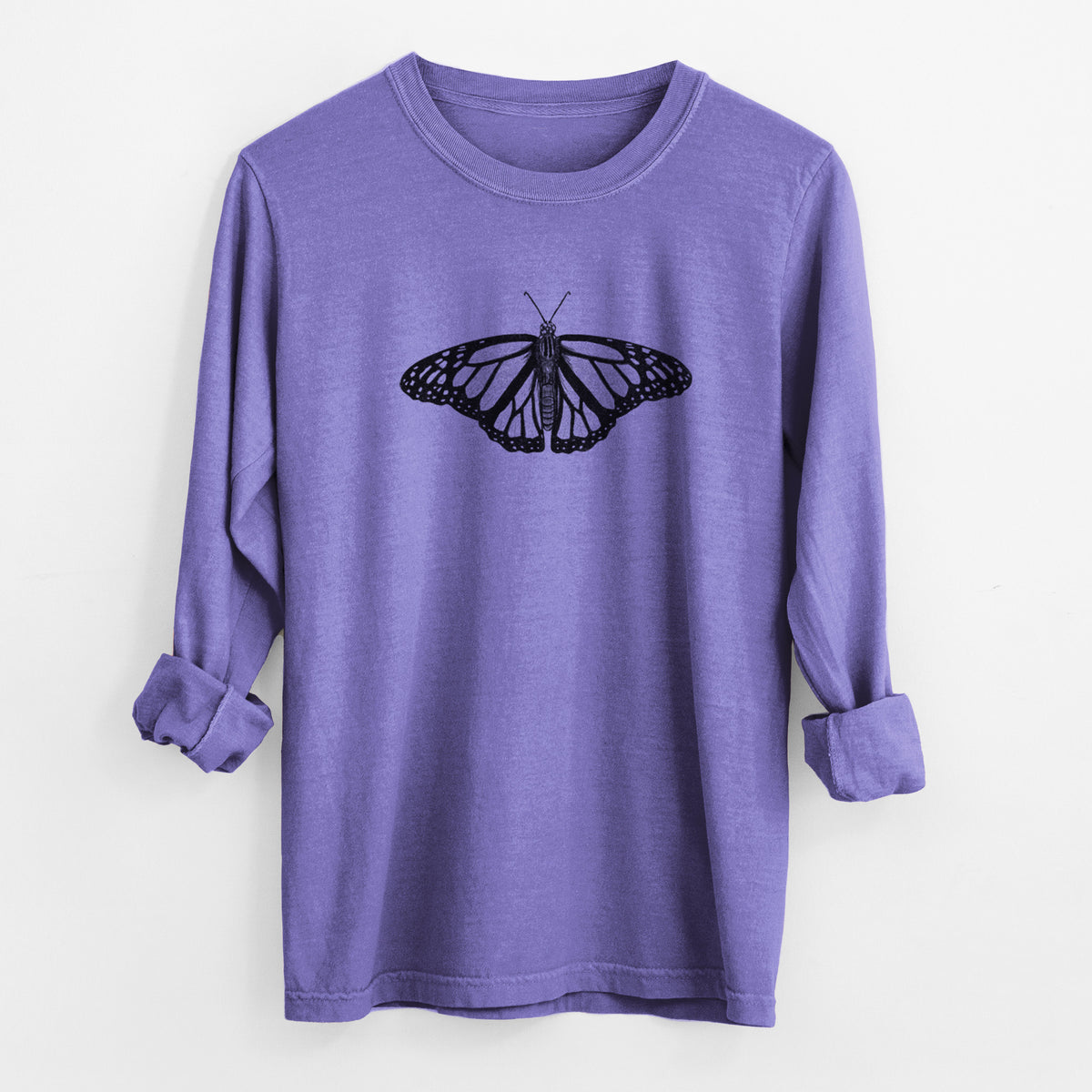 Violet purple Comfort Colors long sleeve shirt laid flat with the cuffs rolled, printed with a detailed black ink illustration of a monarch butterfly with its wings spread.