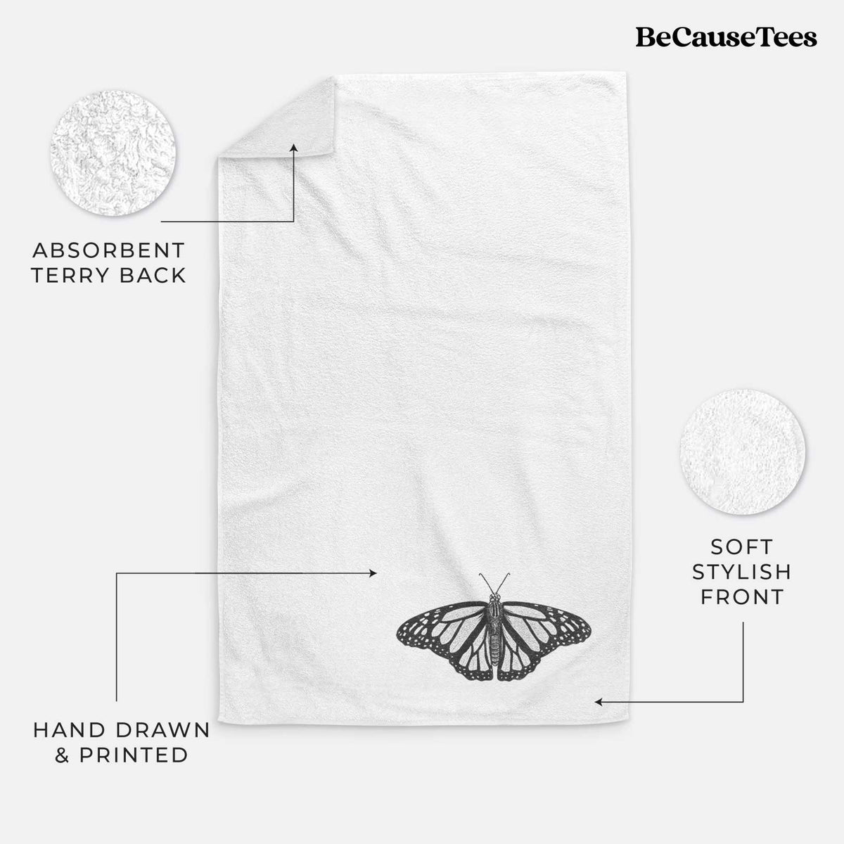 White hand towel printed with a detailed black ink illustration of a monarch butterfly with its wings spread.