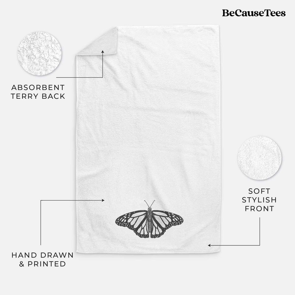 White hand towel printed with a detailed black ink illustration of a monarch butterfly with its wings spread.