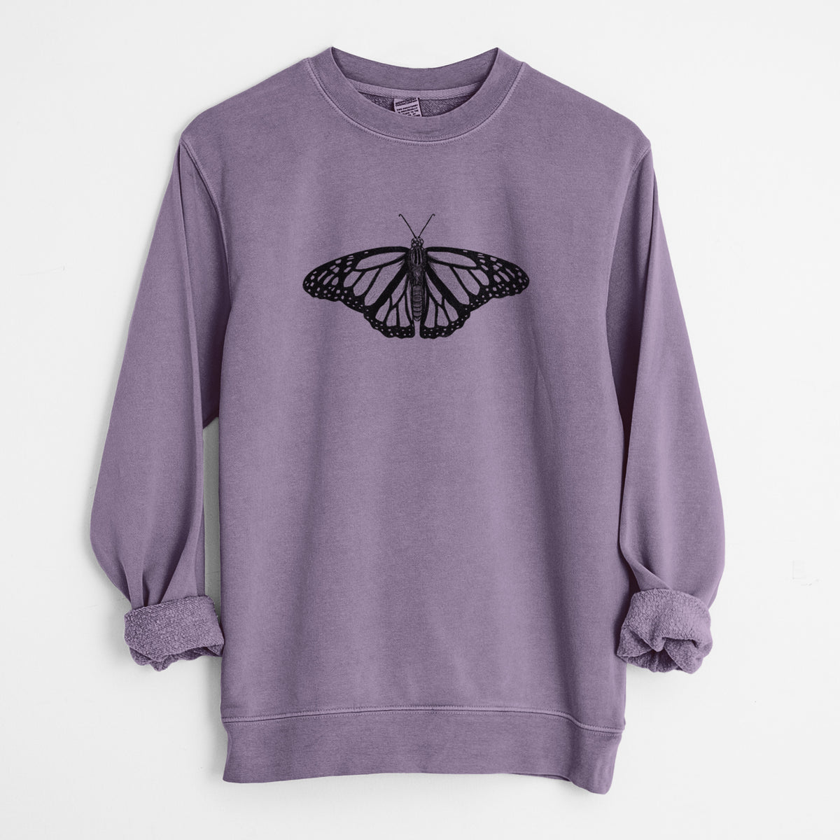 Plum purple pigment dyed crewneck sweatshirt laid flat with the sleeves rolled, printed with a detailed black ink illustration of a monarch butterfly with its wings spread.