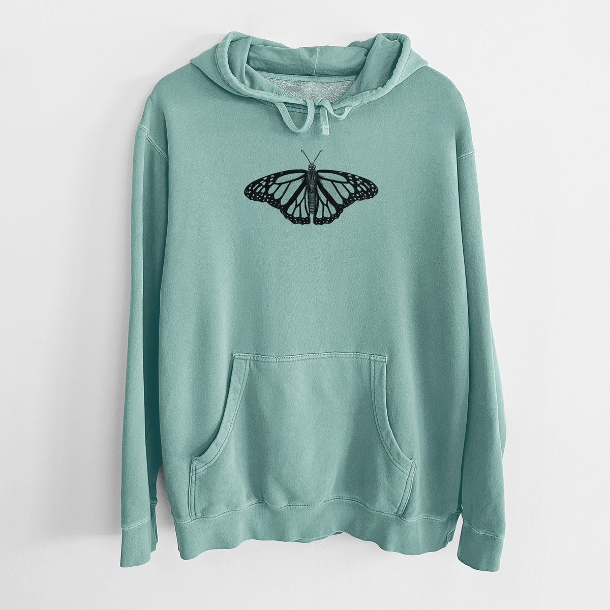 Mint green pigment dyed hoodie laid flat, printed with a detailed black ink illustration of a monarch butterfly with its wings spread.