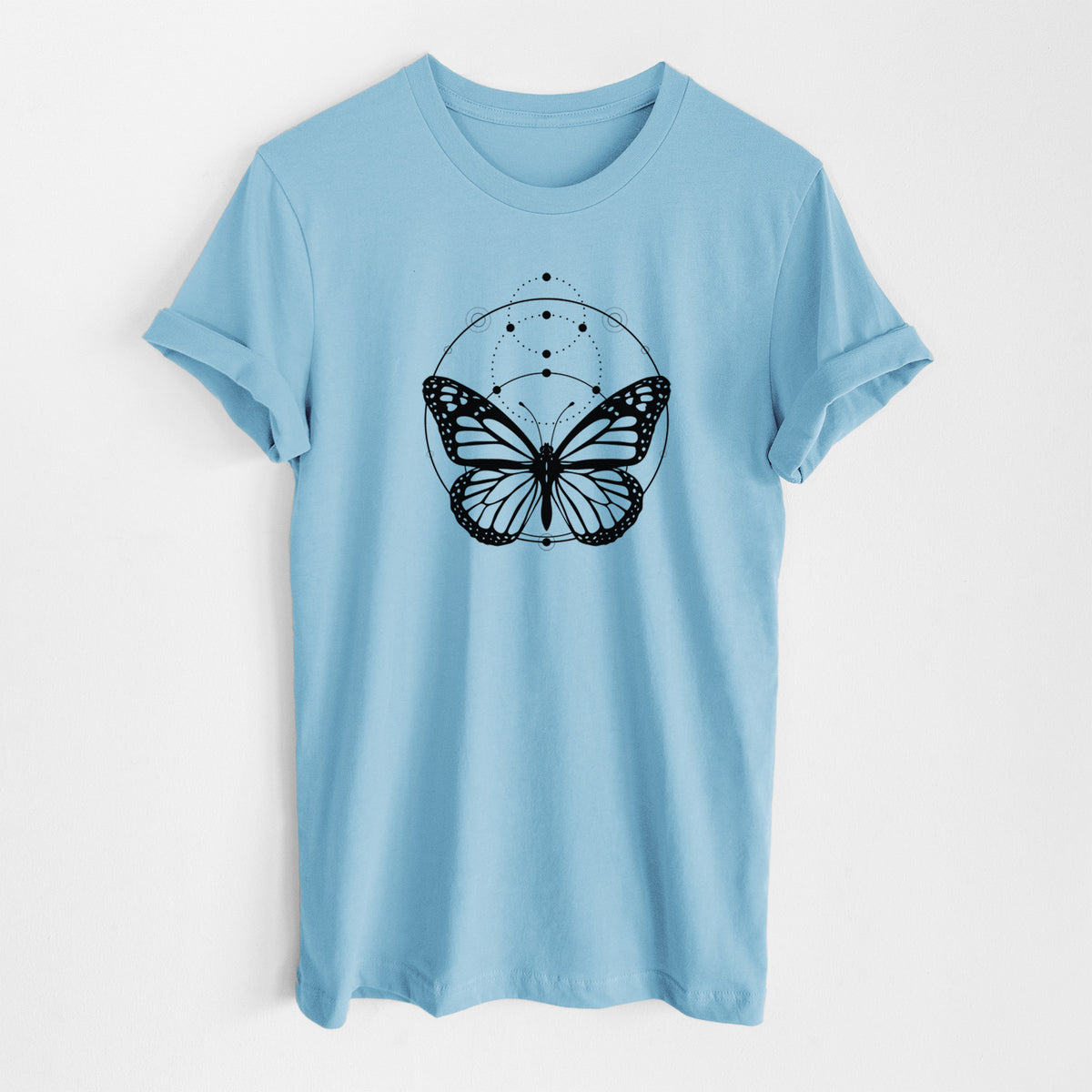 Ocean blue lightweight cotton t-shirt laid flat, printed with a black ink monarch butterfly inside a circle, beneath a line of moon phases.