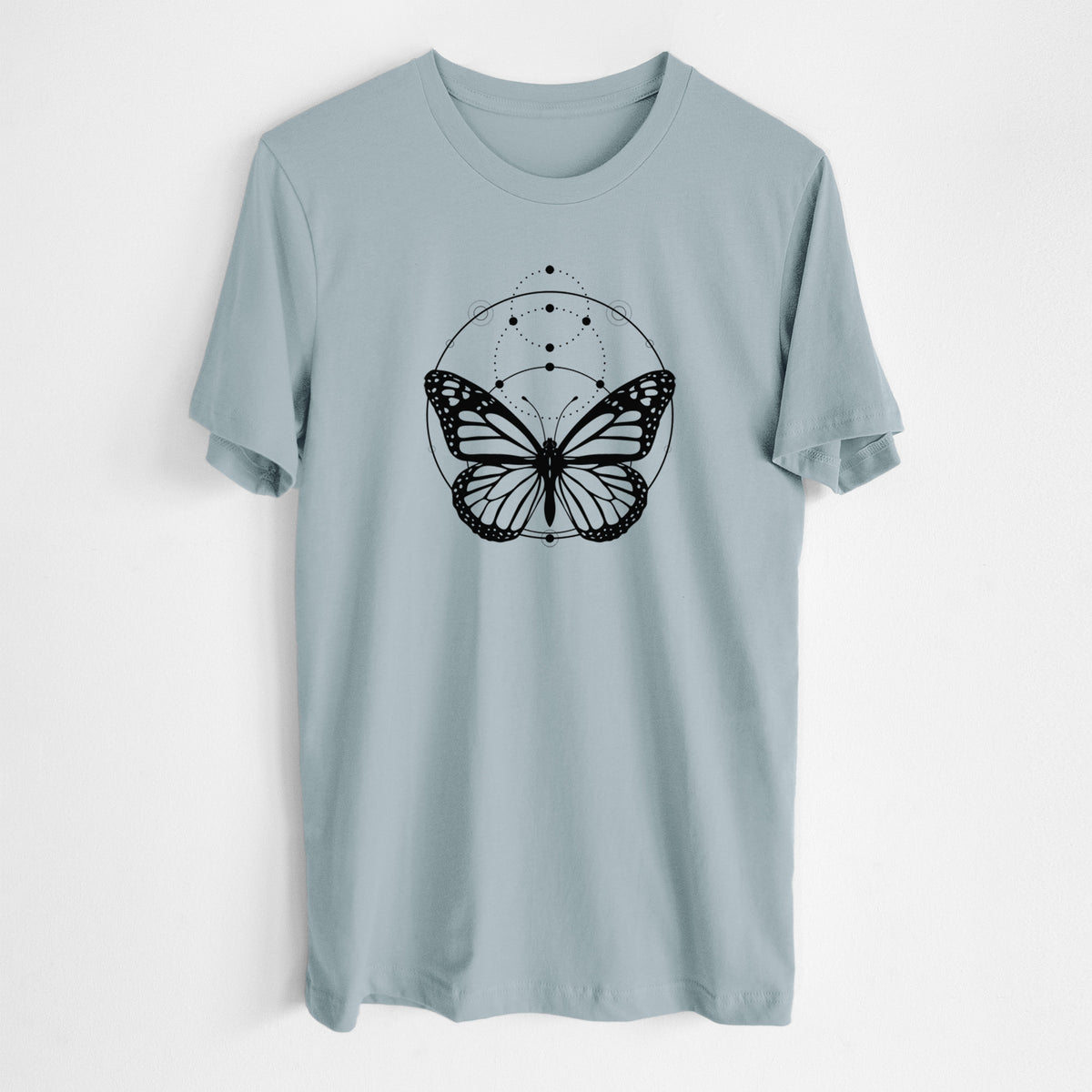 Vintage denim lightweight cotton t-shirt laid flat, printed with a black ink monarch butterfly inside a circle, beneath a line of moon phases.