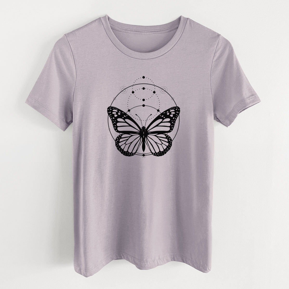 Light violet women's relaxed fit cotton t-shirt laid flat, printed with a black ink monarch butterfly inside a circle, beneath a line of moon phases.