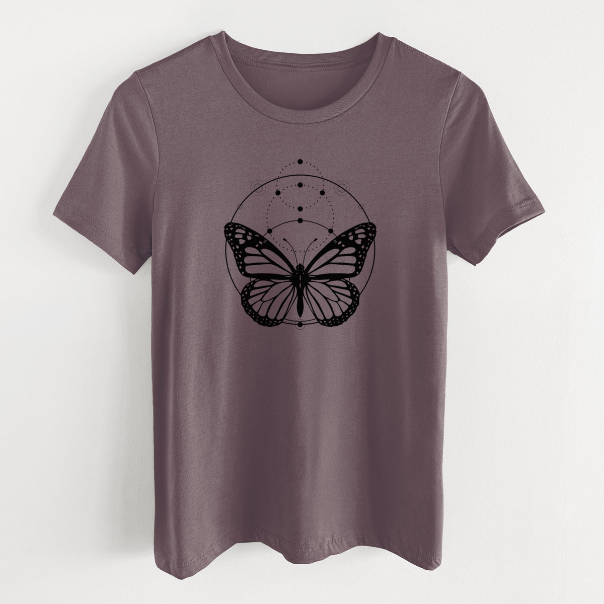 Purple storm women's relaxed fit cotton t-shirt laid flat, printed with a black ink monarch butterfly inside a circle, beneath a line of moon phases.