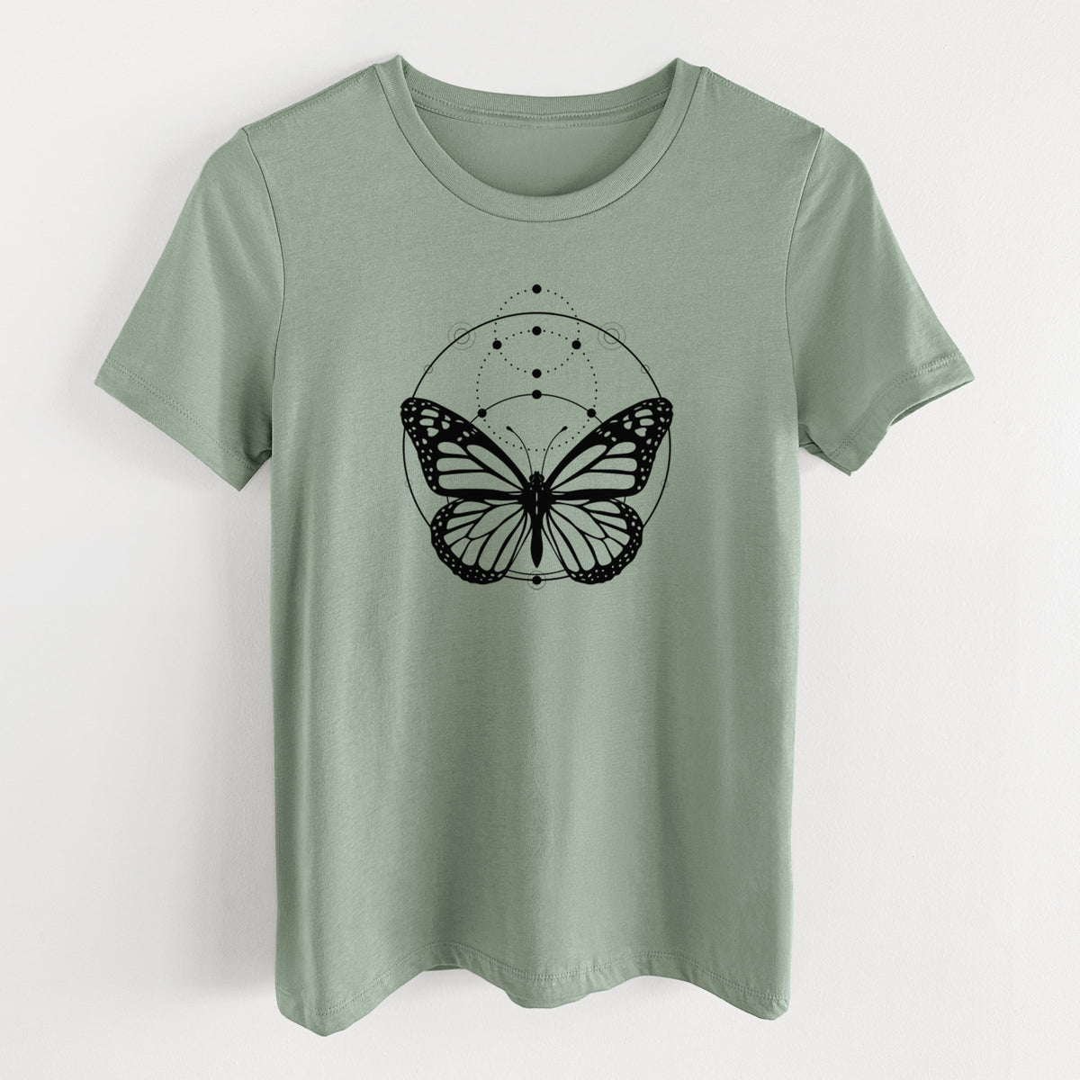 Sage green women's relaxed fit cotton t-shirt laid flat, printed with a black ink monarch butterfly inside a circle, beneath a line of moon phases.