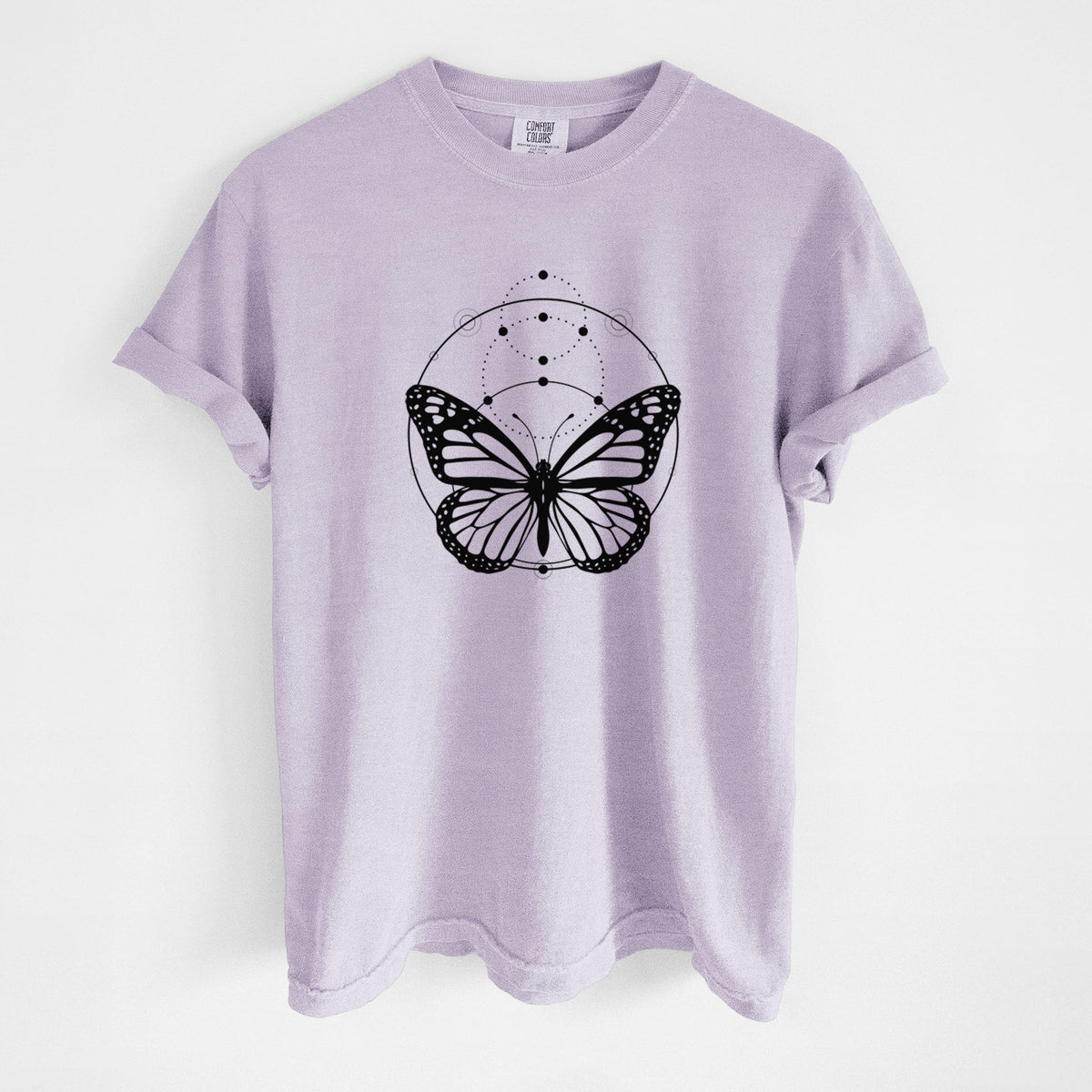 Orchid purple Comfort Colors t-shirt laid flat, printed with a black ink monarch butterfly inside a circle, beneath a line of moon phases.