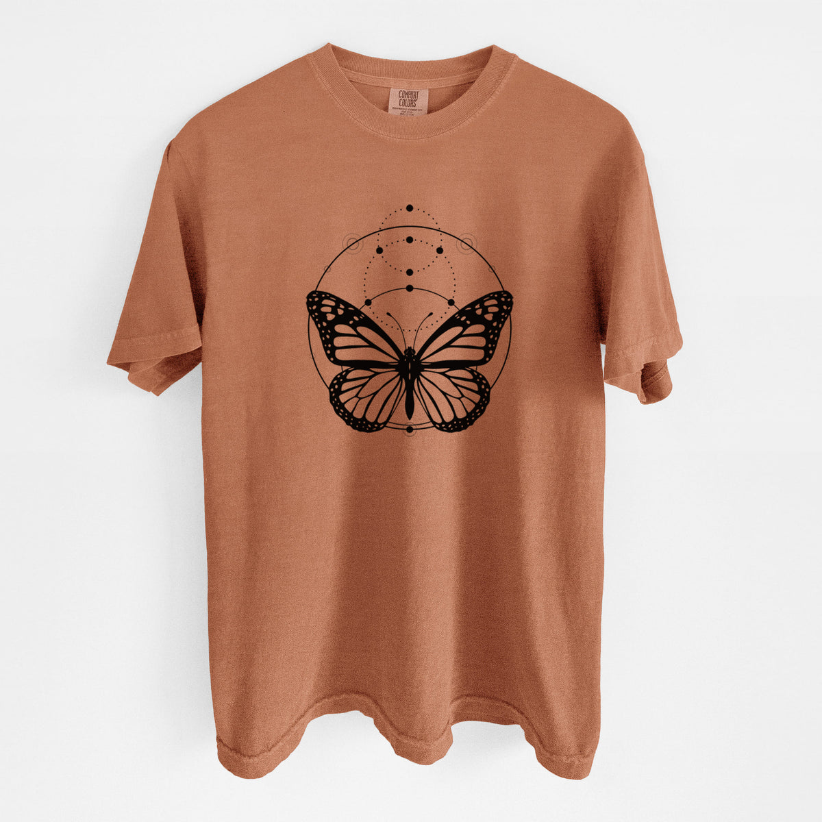 Yam burnt orange Comfort Colors t-shirt laid flat, printed with a black ink monarch butterfly inside a circle, beneath a line of moon phases.