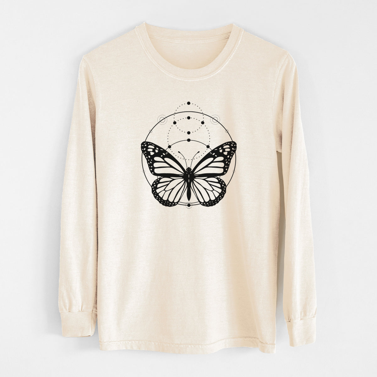 Ivory Comfort Colors long sleeve shirt laid flat, printed with a black ink monarch butterfly inside a circle, beneath a line of moon phases.