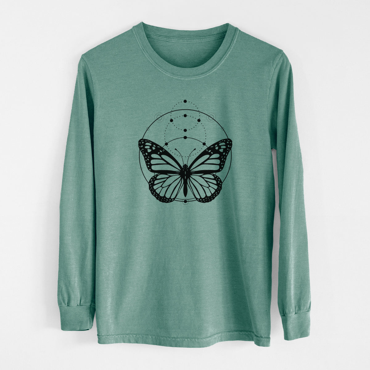 Pine green Comfort Colors long sleeve shirt laid flat, printed with a black ink monarch butterfly inside a circle, beneath a line of moon phases.