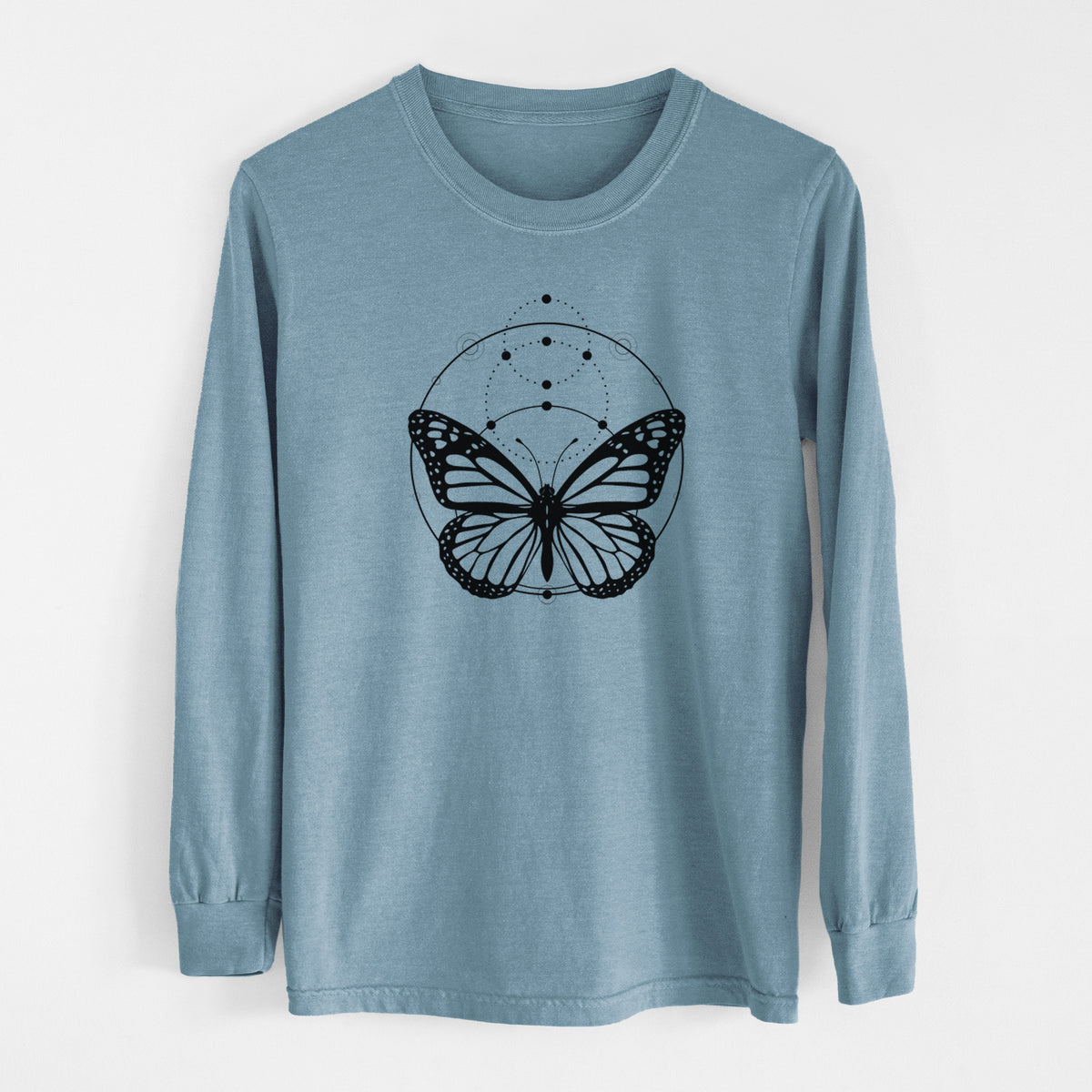 Steel blue Comfort Colors long sleeve shirt laid flat, printed with a black ink monarch butterfly inside a circle, beneath a line of moon phases.