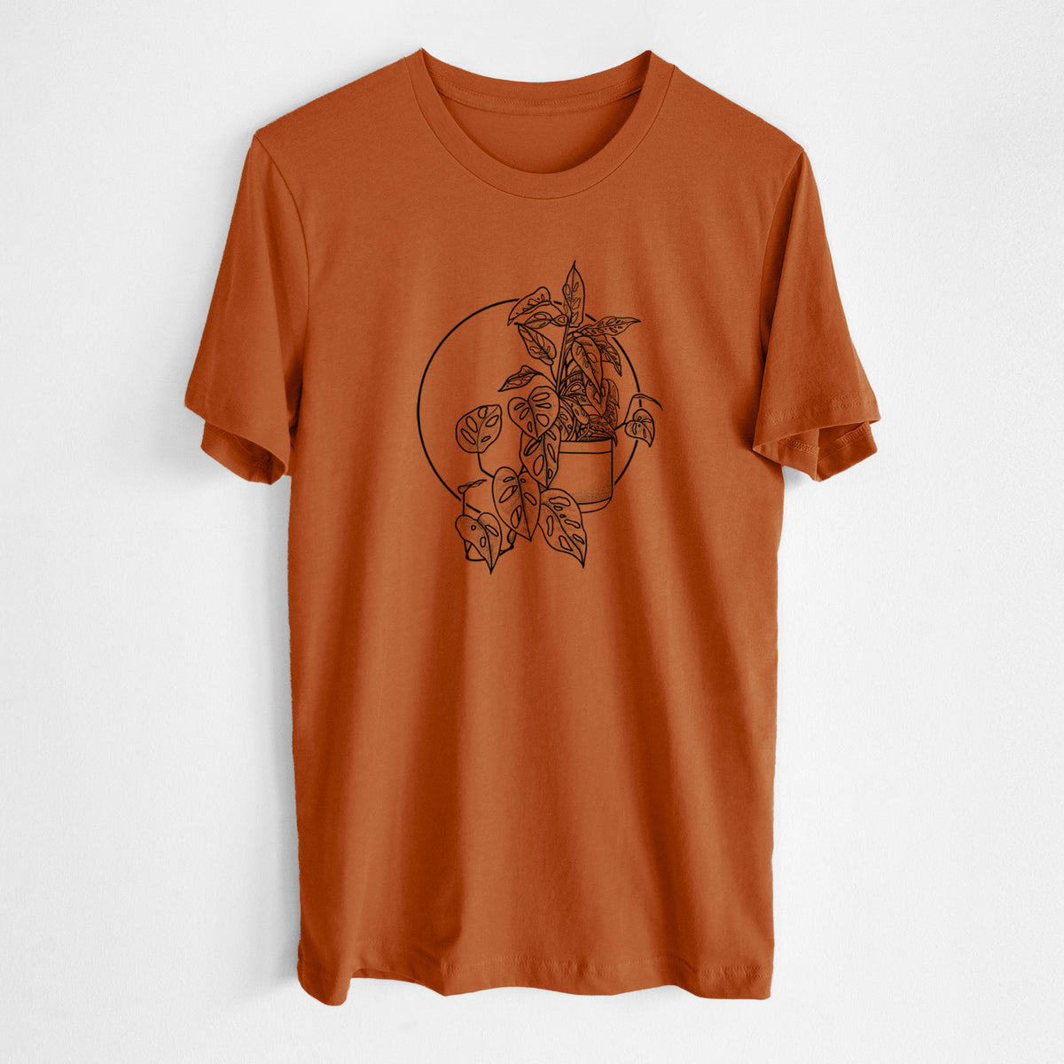 Autumn lightweight cotton t-shirt laid flat, printed with a black ink illustration of a potted Monsteradansonii plant with trailing vines in front of a circle.