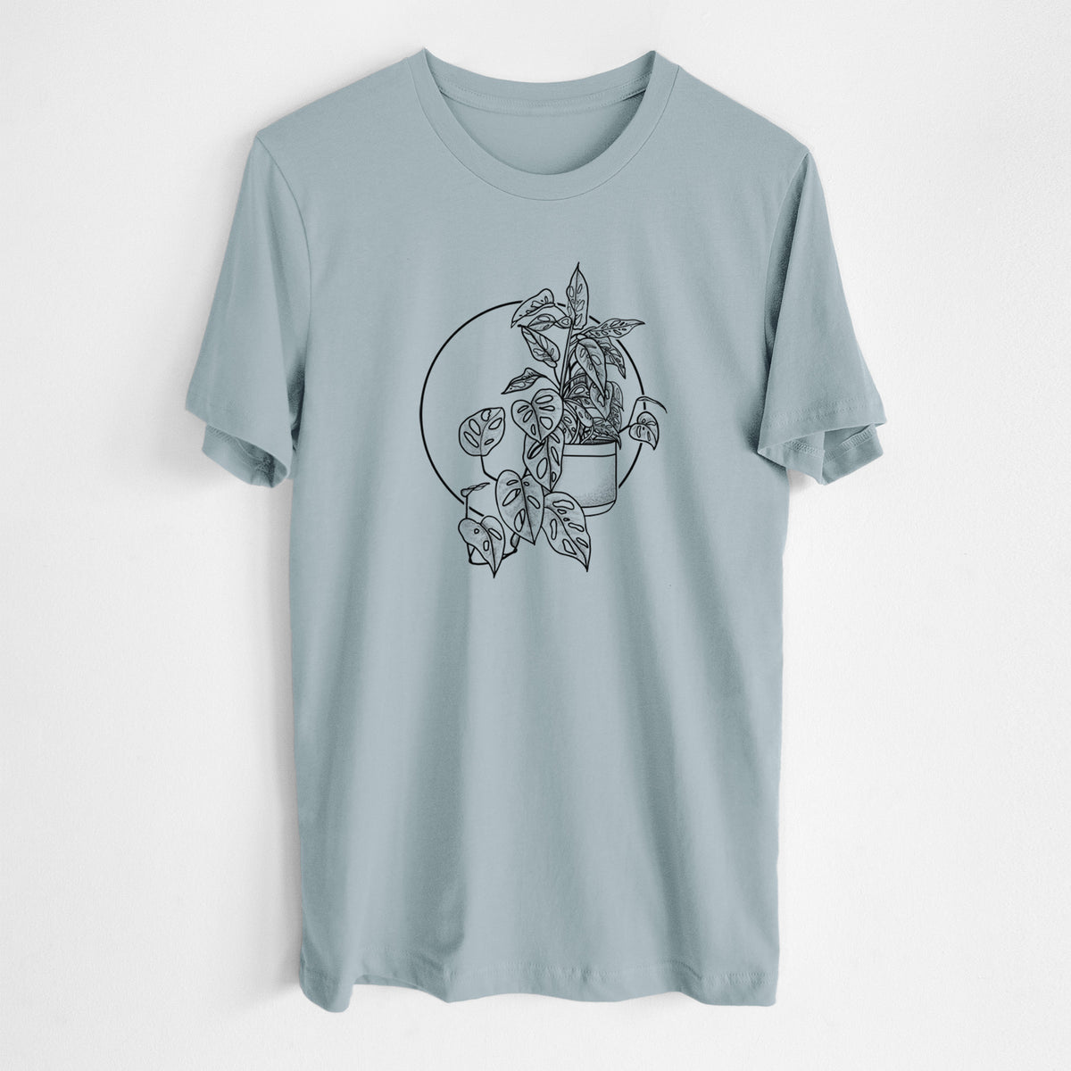 Vintage denim lightweight cotton t-shirt laid flat, printed with a black ink illustration of a potted Monsteradansonii plant with trailing vines in front of a circle.