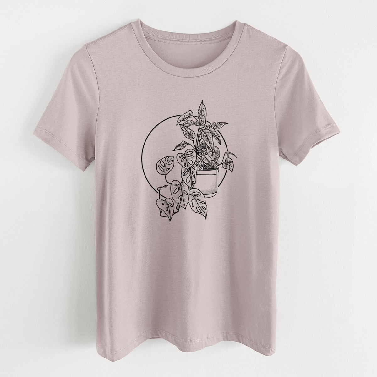 Pink gravel women's relaxed fit cotton t-shirt laid flat, printed with a black ink illustration of a potted Monsteradansonii plant with trailing vines in front of a circle.