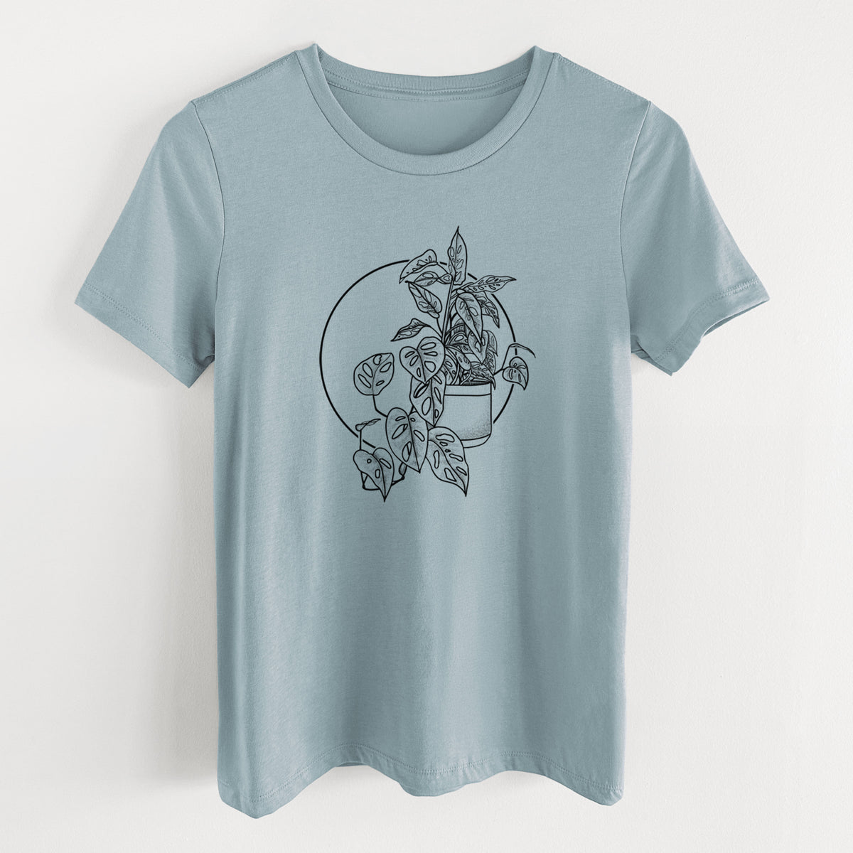Vintage denim women's relaxed fit cotton t-shirt laid flat, printed with a black ink illustration of a potted Monsteradansonii plant with trailing vines in front of a circle.