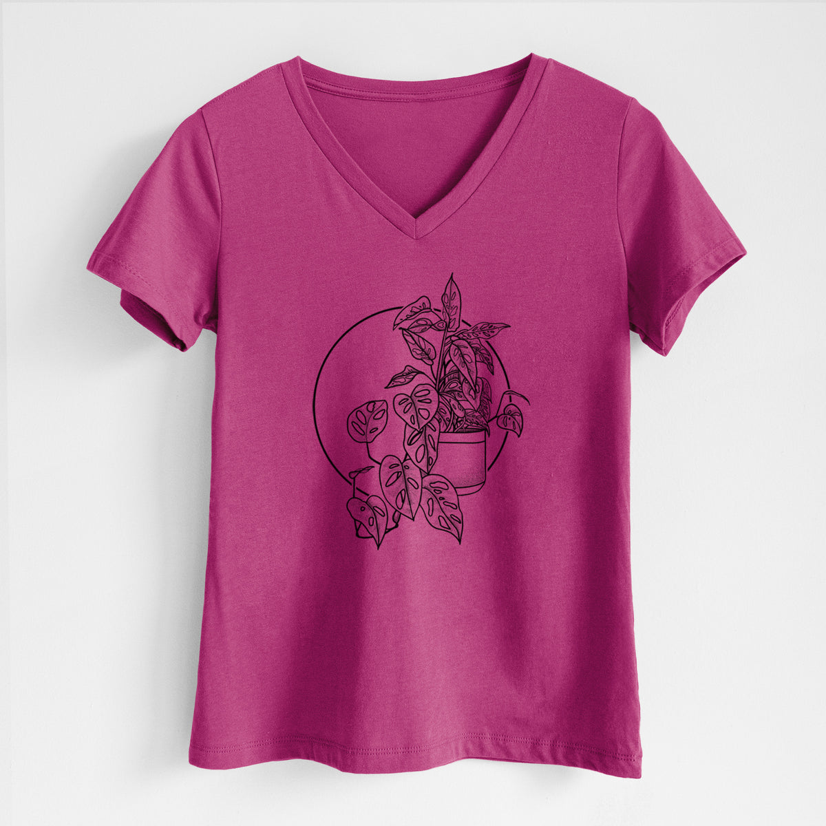 Berry pink women's relaxed fit cotton V-neck t-shirt laid flat, printed with a black ink illustration of a potted Monsteradansonii plant with trailing vines in front of a circle.