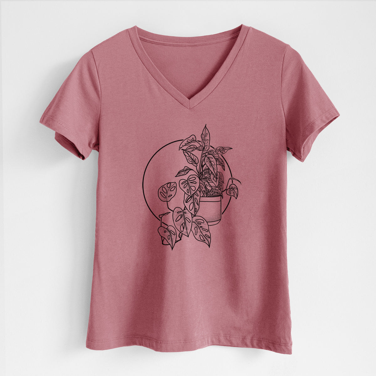Mauve pink women's relaxed fit cotton V-neck t-shirt laid flat, printed with a black ink illustration of a potted Monsteradansonii plant with trailing vines in front of a circle.