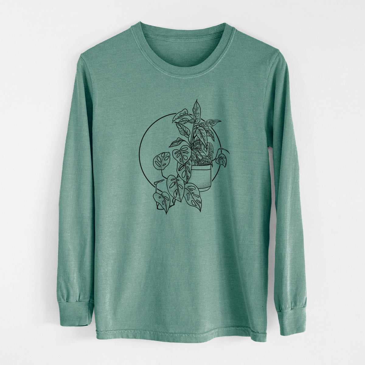 Pine green Comfort Colors long sleeve shirt laid flat, printed with a black ink illustration of a potted Monsteradansonii plant with trailing vines in front of a circle.