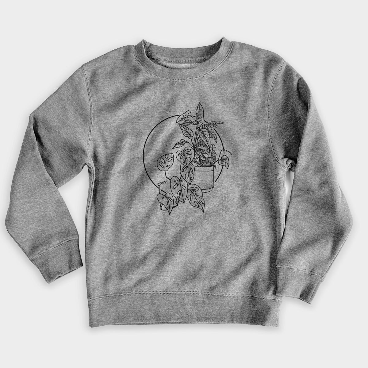 Nickel grey youth crewneck sweatshirt laid flat, printed with a black ink illustration of a potted Monsteradansonii plant with trailing vines in front of a circle.