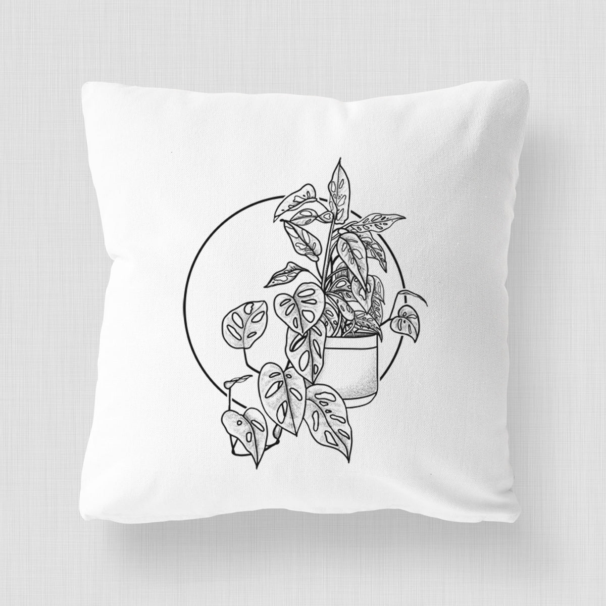 White pillow cover printed with a black ink illustration of a potted Monsteradansonii plant with trailing vines in front of a circle.