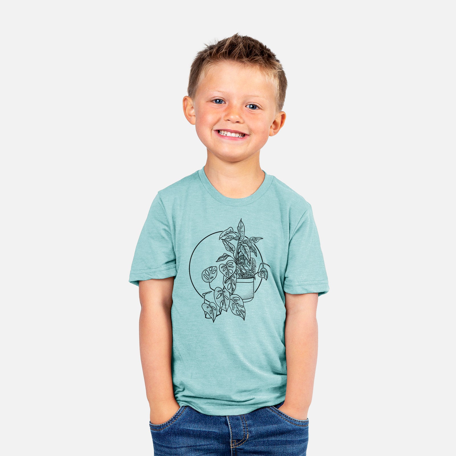 Two youth t-shirts in different colors on hangers, printed with a black ink illustration of a potted Monsteradansonii plant with trailing vines in front of a circle.