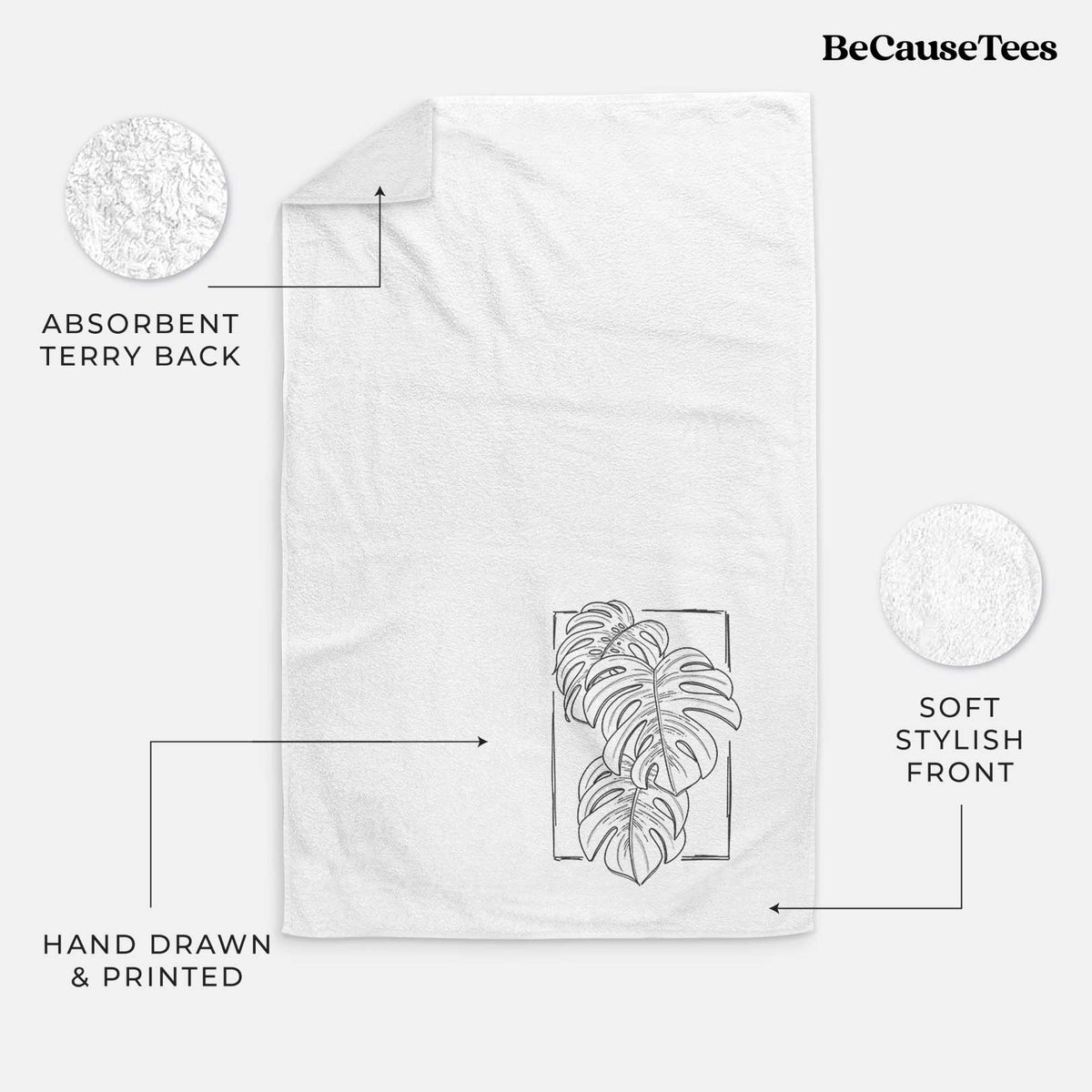 White hand towel printed with a black ink line drawing of Monstera deliciosa leaves inside a rectangle outline.