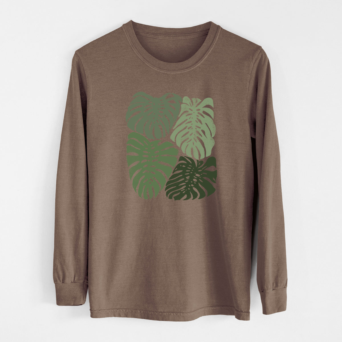 Espresso brown Comfort Colors long sleeve shirt laid flat, printed with a full-color illustration of large green Monstera leaves filling a square.