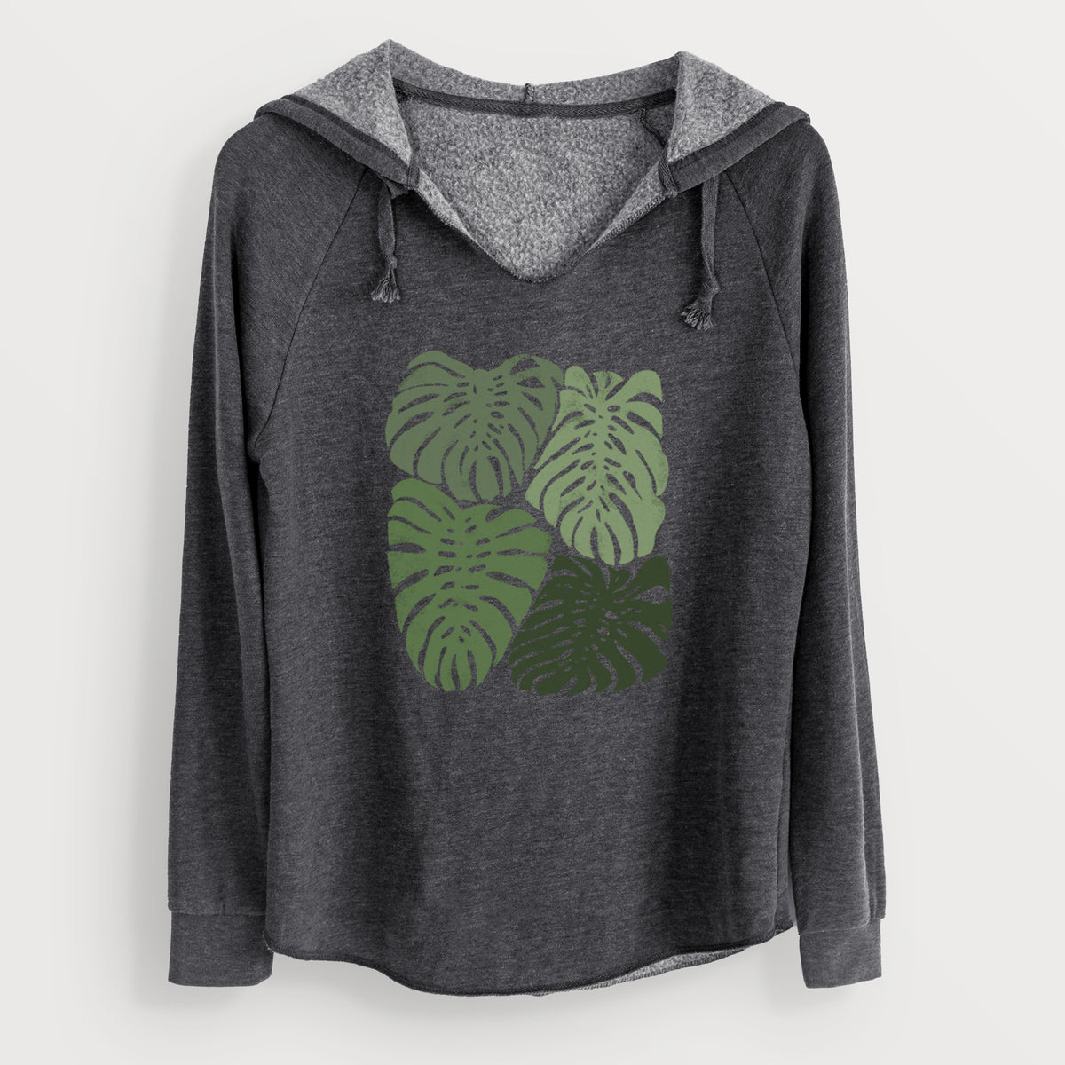 Charcoal grey women's Cali Wave hooded sweatshirt laid flat, printed with a full-color illustration of large green Monstera leaves filling a square.
