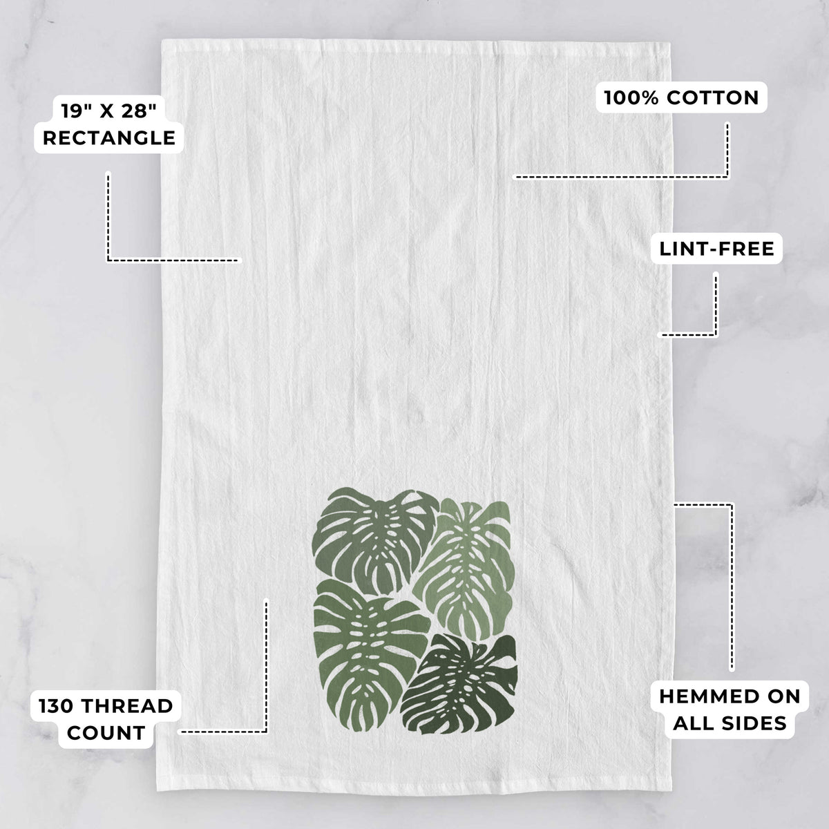 White tea towel printed with a full-color illustration of large green Monstera leaves filling a square, with feature labels: 19 by 28 inch rectangle, 100% cotton, lint-free, 130 thread count, hemmed on all sides.