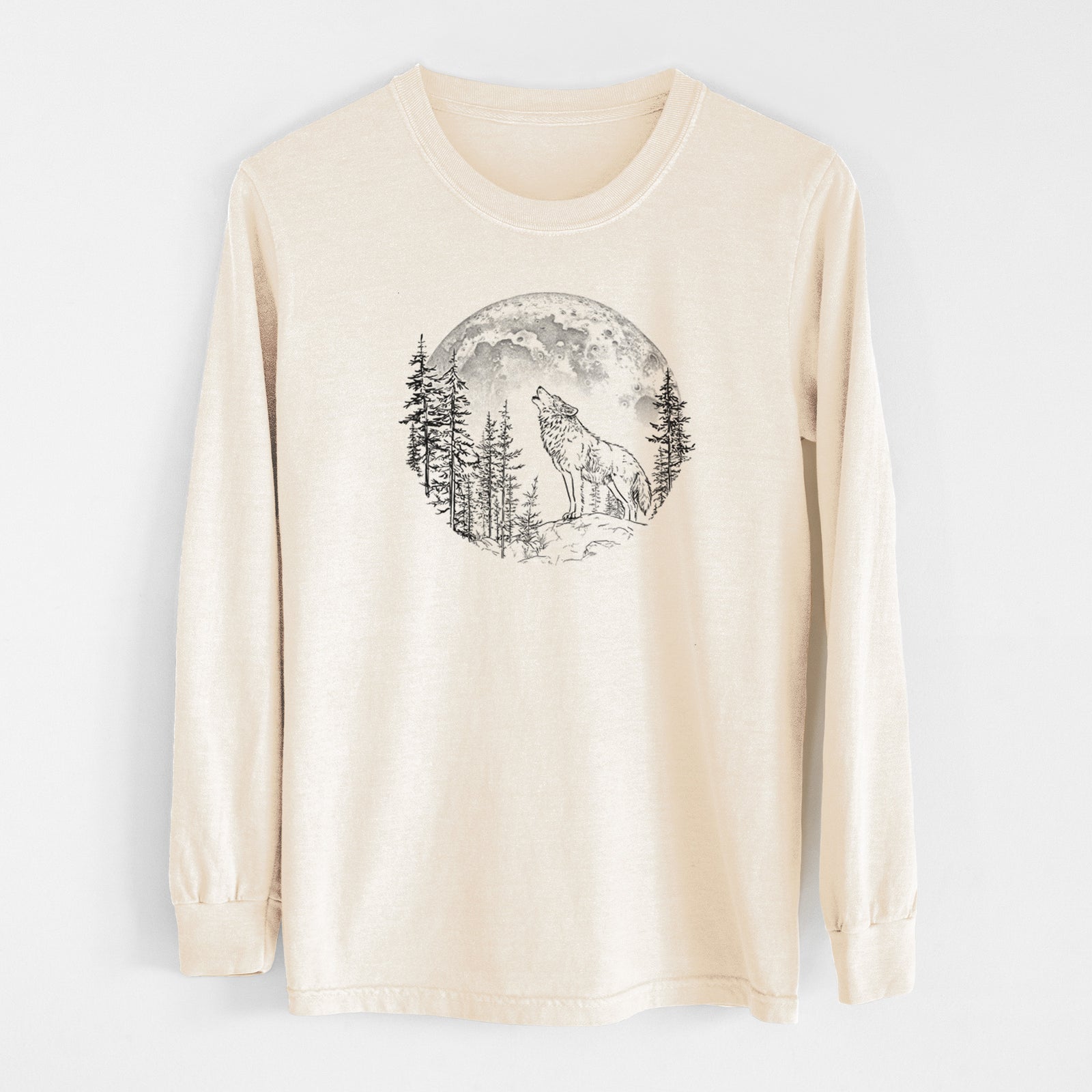 Ivory Comfort Colors long sleeve shirt laid flat, printed with a black ink wolf howling in front of a full moon, surrounded by pine trees.