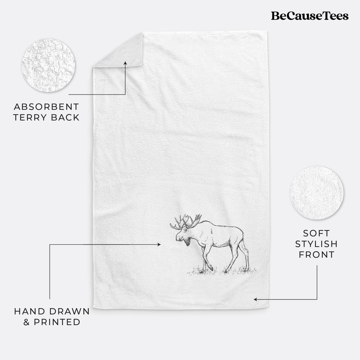 White hand towel printed with a black ink illustration of a bull moose with broad antlers walking.