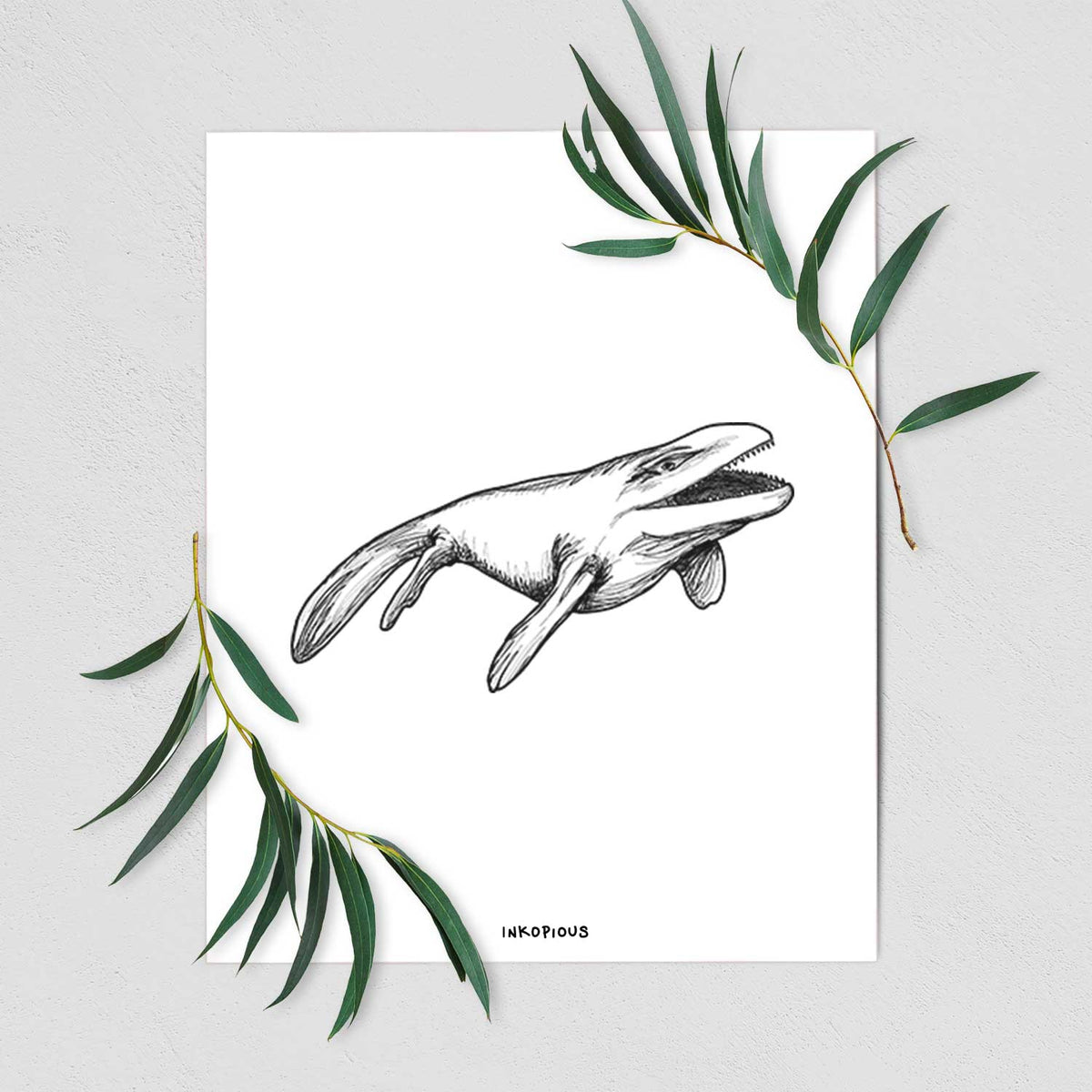 Art print of a black ink illustration of a Mosasaur swimming, shown with eucalyptus leaves.